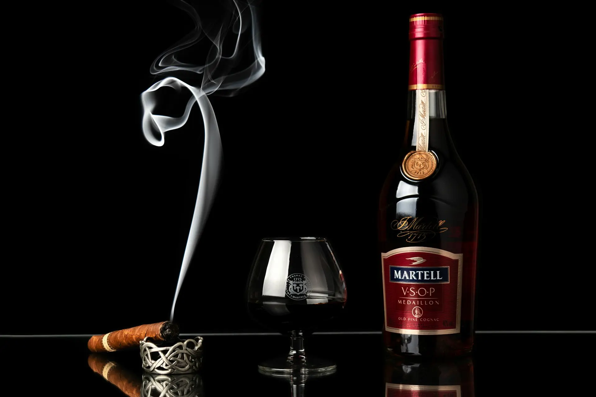 a bottle of wine next to a glass of wine